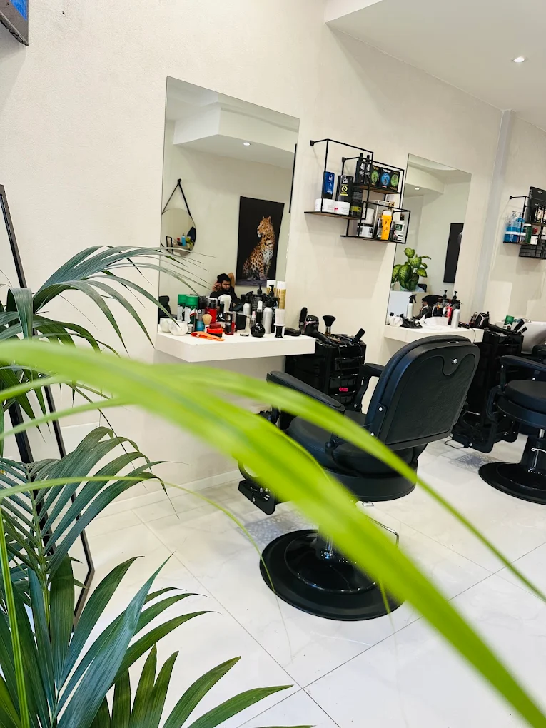 Le postazioni di lavoro con gli specchi e le poltrone da barbiere del salone Om a Lecce